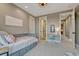 Bedroom featuring a single bed, carpeted flooring, natural light window, and walk through to the hallway at 5428 Forest View Rd, Parker, CO 80134