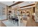 Large dining room with stone accents and an open view into the living room and kitchen at 5428 Forest View Rd, Parker, CO 80134