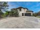 Exterior of home featuring an attached three-car garage, basketball hoop, and beautiful stone accents at 5428 Forest View Rd, Parker, CO 80134