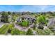 Beautiful two-story stucco home with stone accents, lush landscaping, and a paved driveway on a sunny day at 5428 Forest View Rd, Parker, CO 80134