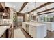 Spacious kitchen featuring a large island, stainless steel appliances, dark wood cabinetry, and stone countertops at 5428 Forest View Rd, Parker, CO 80134