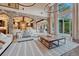 Open-concept living room with stone archways, hardwood floors, and a view of the kitchen at 5428 Forest View Rd, Parker, CO 80134