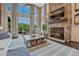 Bright living room featuring a stone fireplace, soaring ceilings, and expansive windows with natural light at 5428 Forest View Rd, Parker, CO 80134