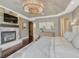 This main bedroom features a stone fireplace, dark wood floors, a king bed, and a decorative light fixture at 5428 Forest View Rd, Parker, CO 80134