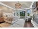 This main bedroom features an elegant light fixture, fireplace, and glass patio doors to enjoy the outdoor views at 5428 Forest View Rd, Parker, CO 80134