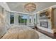 Spacious main bedroom features a stone fireplace, a king bed, large windows with outdoor views, and a decorative light fixture at 5428 Forest View Rd, Parker, CO 80134
