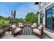 Outdoor patio featuring a fire pit, chairs, and a striped rug against the home's exterior at 5428 Forest View Rd, Parker, CO 80134
