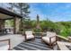 Patio area with outdoor seating and an umbrella, set against a backdrop of lush landscaping at 5428 Forest View Rd, Parker, CO 80134