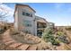 Rear exterior view of house showing the patio, landscaping, and stone accents at 8172 S Langdale Way, Aurora, CO 80016