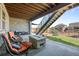 Cozy back patio with stone fireplace, covered seating, and stairway to backyard at 8172 S Langdale Way, Aurora, CO 80016