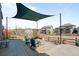 Spacious back patio with shade cover, fire pit, chairs, and fenced backyard at 8172 S Langdale Way, Aurora, CO 80016