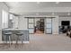 Basement bar area with bar seating leading to space behind sliding barn doors at 8172 S Langdale Way, Aurora, CO 80016