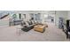 Expansive carpeted basement featuring a comfortable lounge area, kitchenette, and large windows at 8172 S Langdale Way, Aurora, CO 80016