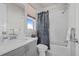 Bright bathroom featuring a shower with patterned curtain, gray vanity and coordinated fixtures at 8172 S Langdale Way, Aurora, CO 80016