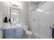 Bright bathroom with a glass-enclosed shower, stylish vanity, and modern fixtures at 8172 S Langdale Way, Aurora, CO 80016