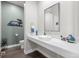 Stylish powder room featuring a vessel sink, decorative mirror, and modern accents at 8172 S Langdale Way, Aurora, CO 80016