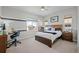 Comfortable bedroom featuring a study area, large window with neighborhood views, and warm, inviting decor at 8172 S Langdale Way, Aurora, CO 80016