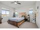Cozy bedroom featuring a unique wooden bed frame, complemented by natural light and minimalist decor at 8172 S Langdale Way, Aurora, CO 80016