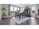 Bright dining room with large windows, modern decor, and wood flooring at 8172 S Langdale Way, Aurora, CO 80016