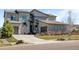 Beautiful home featuring a stone and siding exterior, professional landscaping, and a large driveway leading to an attached garage at 8172 S Langdale Way, Aurora, CO 80016