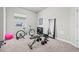 Well-lit home gym featuring exercise equipment and a full-length mirror, creating an optimal workout space at 8172 S Langdale Way, Aurora, CO 80016