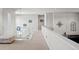 Upstairs hallway featuring modern railing, neutral colors, and lots of light at 8172 S Langdale Way, Aurora, CO 80016