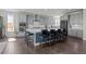 A large kitchen with an island, wooden floors, stainless steel appliances, and grey cabinets at 8172 S Langdale Way, Aurora, CO 80016