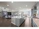 Open-concept kitchen and living area with granite countertops, stainless appliances, and abundant natural light at 8172 S Langdale Way, Aurora, CO 80016