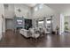 Spacious living room featuring a fireplace, large windows, high ceilings, and stylish decor at 8172 S Langdale Way, Aurora, CO 80016