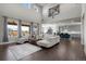 Open-concept living space featuring hardwood floors, large windows, a modern kitchen, and elegant furnishings at 8172 S Langdale Way, Aurora, CO 80016