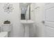 Half bath featuring a pedestal sink, and modern fixtures at 8958 Southurst St, Littleton, CO 80129