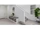 Bright entryway features a built-in bench with storage and stairs to upper levels at 8958 Southurst St, Littleton, CO 80129