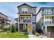 Charming two-story home with a well-manicured lawn and inviting yellow doors at 8958 Southurst St, Littleton, CO 80129