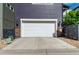 Exterior showcasing the two-car garage with a concrete driveway at 8958 Southurst St, Littleton, CO 80129