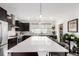 Modern kitchen with a large white quartz island, stainless steel appliances, and stylish cabinetry at 8958 Southurst St, Littleton, CO 80129