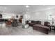Open-concept living space with hardwood floors, a large sofa, and stylish decor at 8958 Southurst St, Littleton, CO 80129