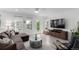 Spacious living room featuring a large sectional sofa and a modern ceiling fan at 8958 Southurst St, Littleton, CO 80129