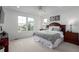 Main bedroom featuring great natural light, carpeted floors, and two bedside tables with lamps at 8958 Southurst St, Littleton, CO 80129