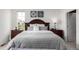 Comfortable main bedroom features a king size bed, dark wood furniture and modern art at 8958 Southurst St, Littleton, CO 80129