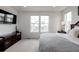 Bright main bedroom with plush carpet, modern furnishings, and lots of natural light at 8958 Southurst St, Littleton, CO 80129