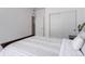 Bright bedroom with light neutral finishes, closet, and a view to the bathroom at 8958 Southurst St, Littleton, CO 80129