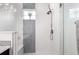 Modern shower features glass doors, a built-in seat, and accent tile at 8958 Southurst St, Littleton, CO 80129