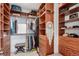 Spacious walk-in closet with custom shelving and a comfortable bench at 8958 Southurst St, Littleton, CO 80129
