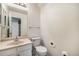 Small bathroom with toilet, sink, and shower at 1282 S Troy St, Aurora, CO 80012