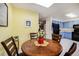 Charming dining area with a round table and four chairs, and a view into the kitchen at 1282 S Troy St, Aurora, CO 80012