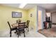 Cozy dining area with a round table and four chairs, and access to a bathroom at 1282 S Troy St, Aurora, CO 80012