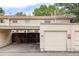 Attached garage with carport and wooden fence at 1282 S Troy St, Aurora, CO 80012