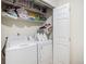 Laundry room with washer, dryer, and shelving at 1282 S Troy St, Aurora, CO 80012