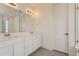 A spacious bathroom with double sinks, large mirror and white cabinets providing functional design and practicality at 2525 Lupton Ln, Lafayette, CO 80026