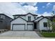 Beautiful two-story home with a two car garage, white siding and black trim on a sunny day at 2525 Lupton Ln, Lafayette, CO 80026